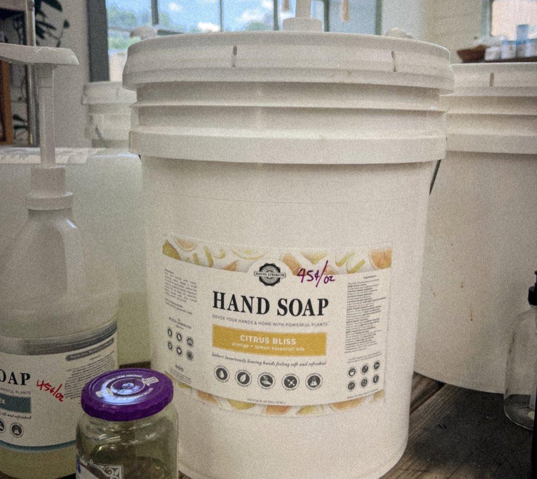 Five-gallon refill bucket of Citrus Bliss hand soap marked 45 cents per ounce